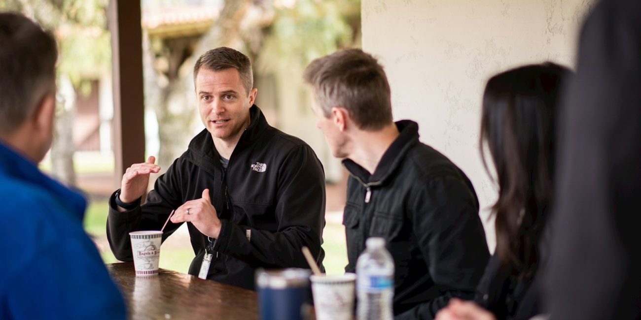 a group of people sitting at a table
