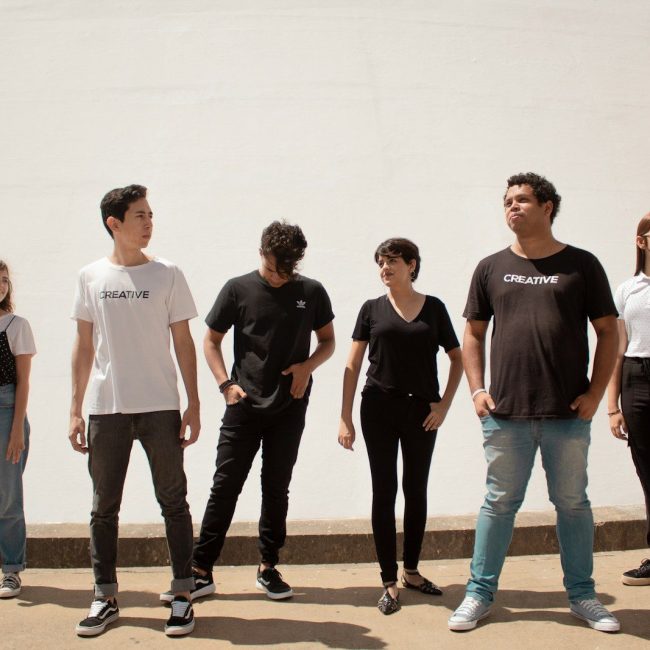 group of people standing on brown floor